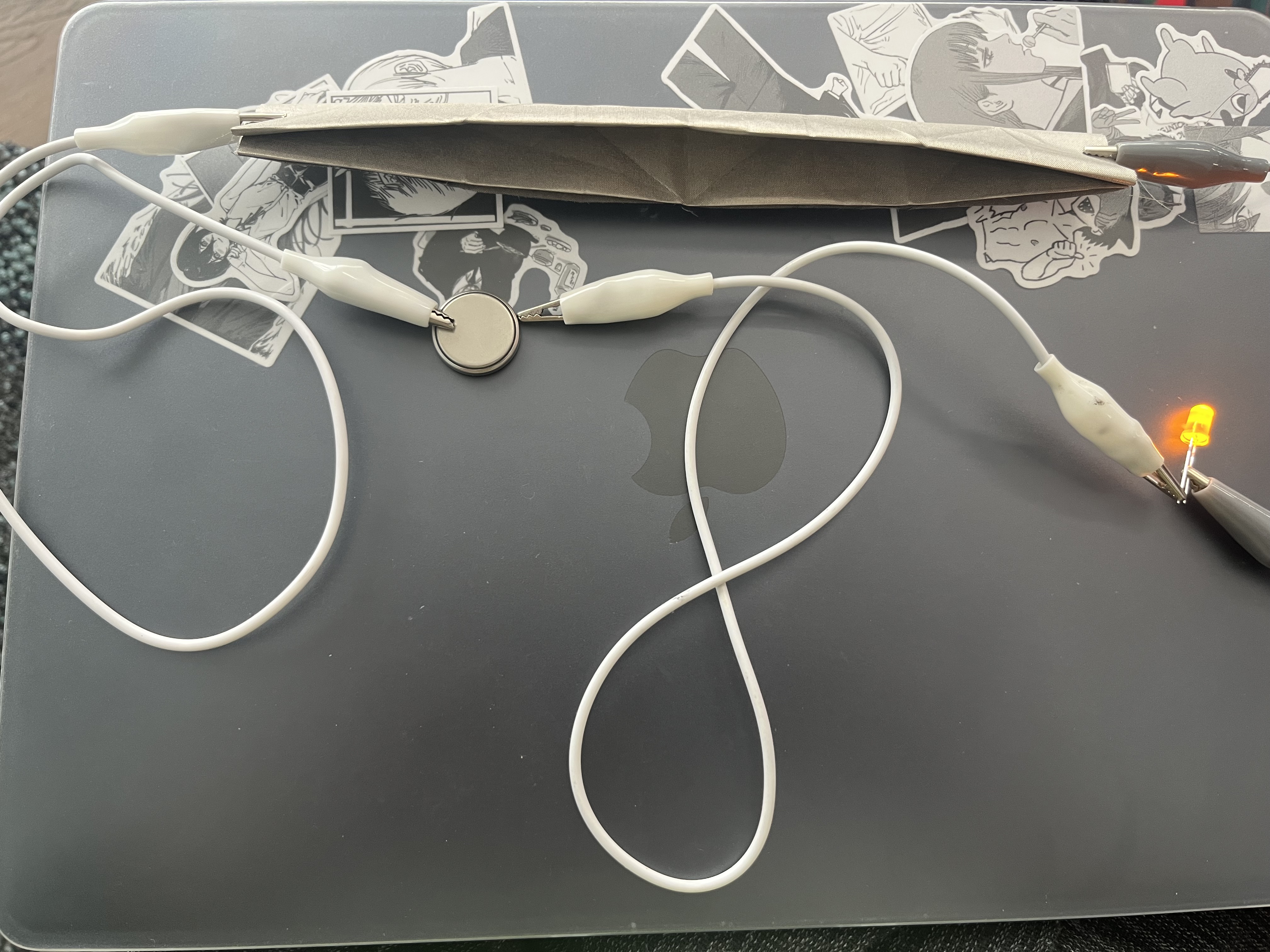 Successfully activating a circuit through stable alligator clip connections.